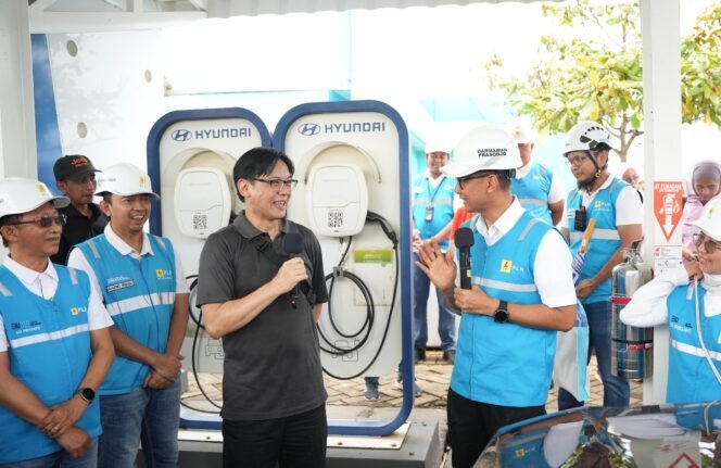 
					Direktur Utama PLN, Darmawan Prasodjo menyapa pengguna kendaraan listrik yang tengah melakukan pengisian daya di Stasiun Pengisian Kendaraan Listrik Umum (SPKLU) di Rest Area KM 379A Ruas Tol Semarang-Batang, Jawa Tengah pada Rabu (25/12).